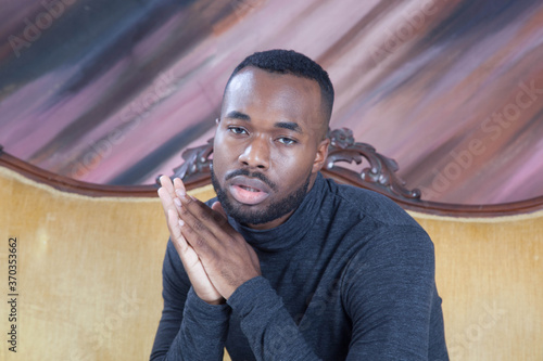 Fotografie Handsome Black man sitting thoughtfully