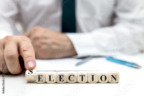 businessman or election worker changes the word election to selection