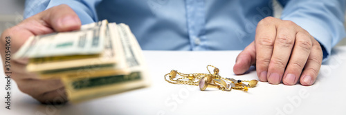 Fotografie Buying gold jewelry, us dollars and hand of a businessman, panorama