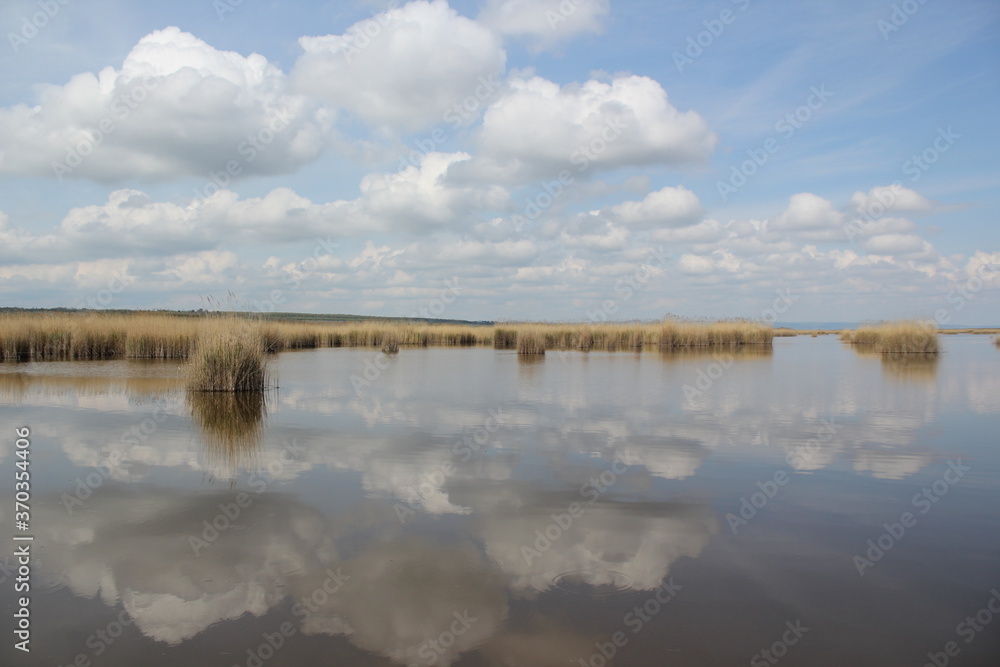 clouds reflecting at Lake Neusiedl in austria clouds reflecting at Lake Neusiedl in austria