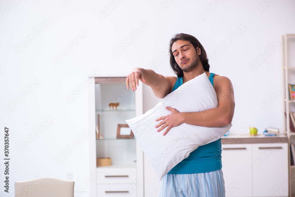 Young man waking up at home Young man waking up at home