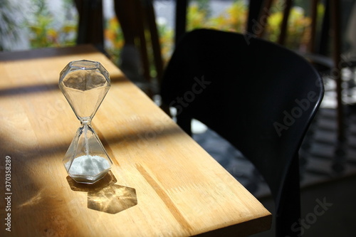 glass sanr watch low key light under lath on wood table photo