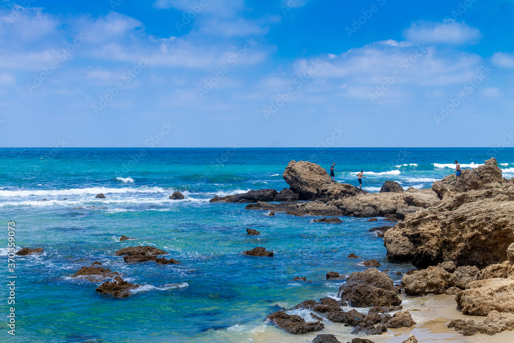 A beautiful view of the rocks going into the sea on the Givat Olga beach. Israel.
