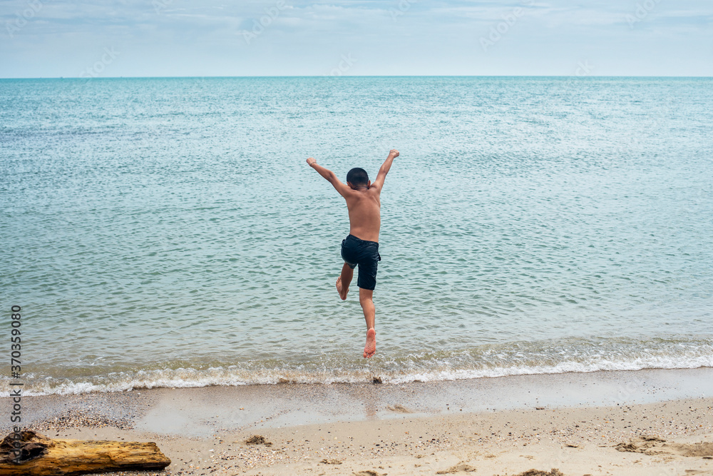 happy boy running into the sea , Summer vacation concept. happy boy running into the sea , Summer vacation concept.