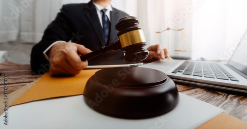 Business and lawyers discussing contract papers with brass scale on desk in office. Law, legal services, advice, justice and law concept