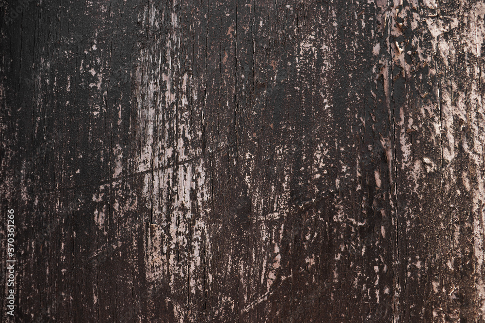 Obraz premium Dark texture of an old cracked paint on the door