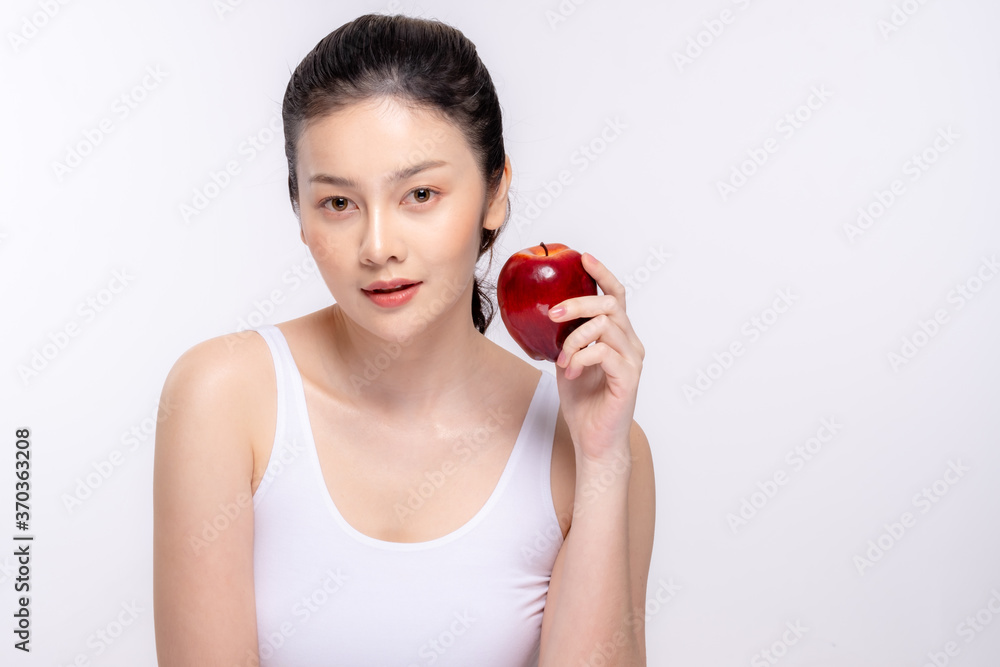 Beautiful young woman with clean fresh skin . She holds an apple. Facial treatment . Cosmetology , beauty and spa . Skin care Beautiful young woman with clean fresh skin . She holds an apple. Facial treatment . Cosmetology , beauty and spa . Skin care