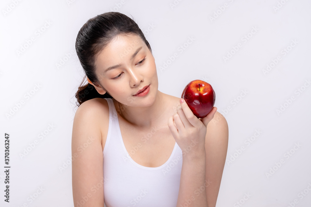 Beautiful young woman with clean fresh skin . She holds an apple. Facial treatment . Cosmetology , beauty and spa . Skin care Beautiful young woman with clean fresh skin . She holds an apple. Facial treatment . Cosmetology , beauty and spa . Skin care