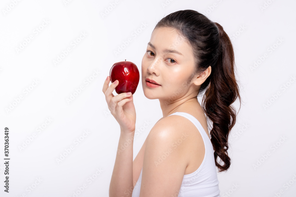 Beautiful young woman with clean fresh skin . She holds an apple. Facial treatment . Cosmetology , beauty and spa . Skin care Beautiful young woman with clean fresh skin . She holds an apple. Facial treatment . Cosmetology , beauty and spa . Skin care