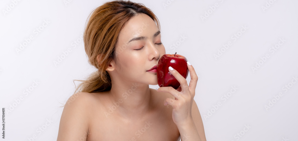 Beautiful young woman with clean fresh skin . She holds an apple. Facial treatment . Cosmetology , beauty and spa . Skin care Beautiful young woman with clean fresh skin . She holds an apple. Facial treatment . Cosmetology , beauty and spa . Skin care