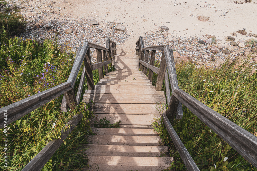 Picturesque wooden stairs leading downwards to a Beach at the Baltic Sea in Germany