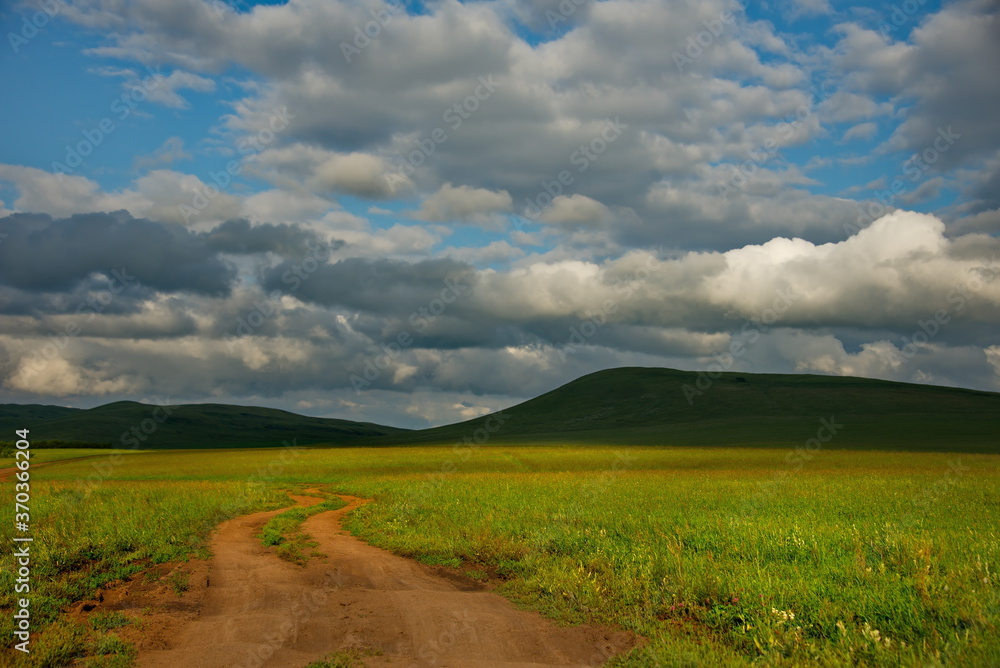 Obraz premium Russia. Republic Of Khakasia. Endless steppes among picturesque hilly mountains near the village of Shira.