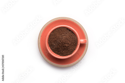 Ground coffee powder in cup isolated on a white background.