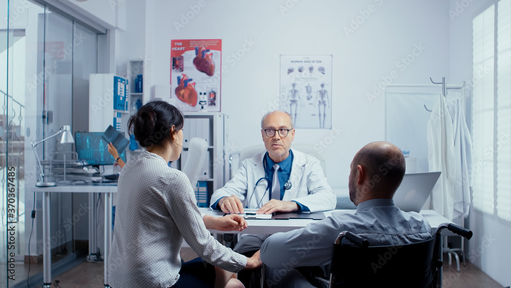 Obraz premium In modern clinic for disabled and handicapped recovery, young man in wheelchair is seeking consultation and treatment. Dsabled disability handicapped person treatment in modern private hospital or
