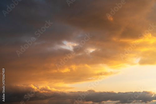 Beautiful bright sunset sky. Dramatic colorful clouds after sunset. Nature  sunset clouds backgrounds.