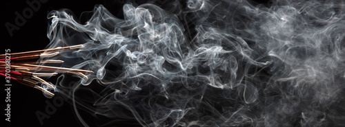 Creative illustration of incense stick aroma with smoke isolated on black background