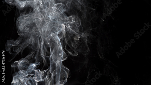 Smoke isolated on black background. Movement of white smoke