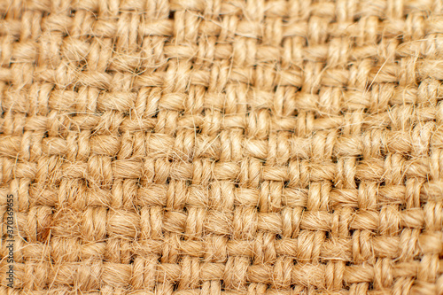 Brown burlap background. Macro of natural rag cloth texture. Selective focus