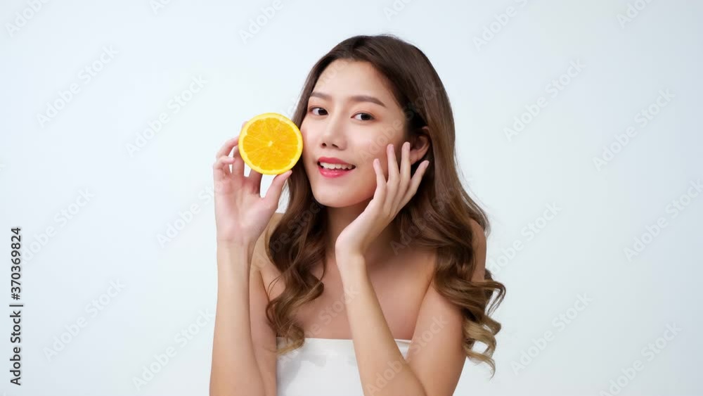 Portrait of beautiful asian woman looking to camera with attractive smile. People with beauty and skin care concept..4K UHD. young woman with oranges. Portrait of beautiful asian woman looking to camera with attractive smile. People with beauty and skin care concept..4K UHD. young woman with oranges.