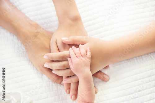 Wallpaper Mural Father mother and daughter, son baby holding hands family. people relationship concept. Torontodigital.ca