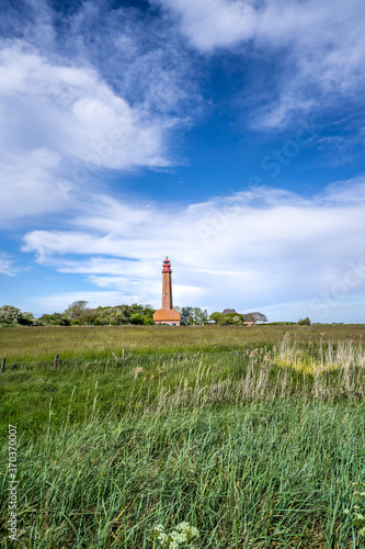 The beautiful Lighthouse Of Flügge On The Isle Of Fehmarn at the Baltic Sea in Germany. Summer in Germany. photo