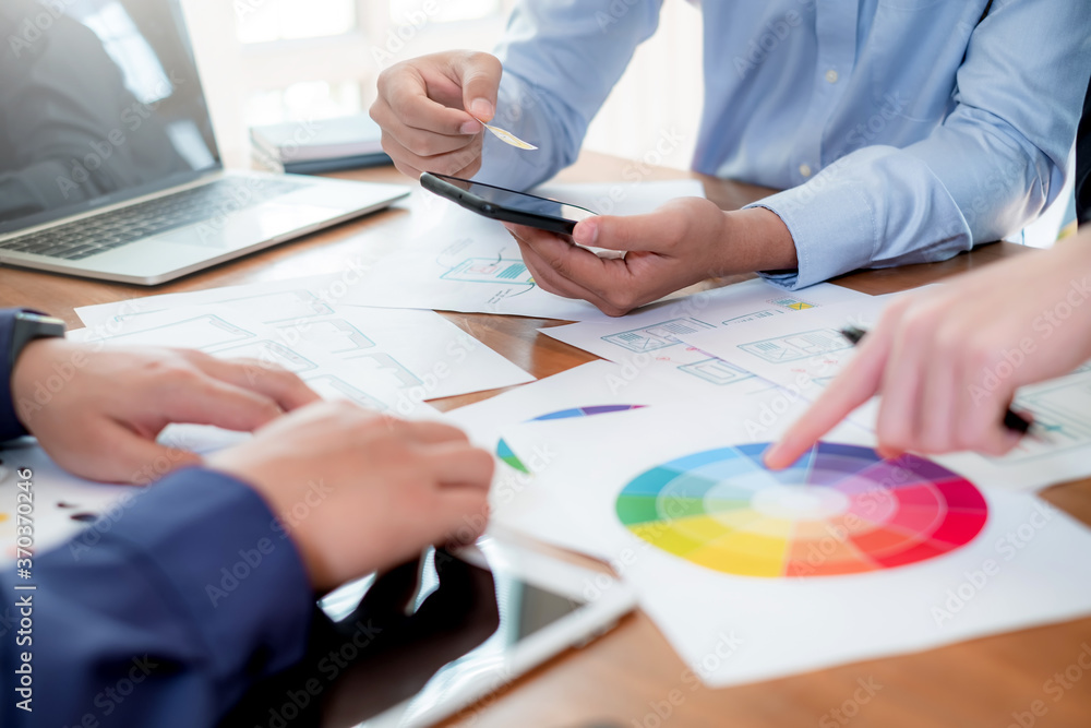 UI UX Graphic designer. Group of designer creativity drawing a website outline and website ux app development on mobile phone. UI UX Graphic designer. Group of designer creativity drawing a website outline and website ux app development on mobile phone.