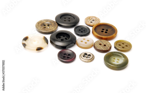 A bunch of buttons of various types and sizes on a white background