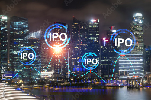 Initial public offering hologram, night panoramic city view of Singapore. The financial center for multinational corporations in Asia. The concept of boosting the growth by IPO process.