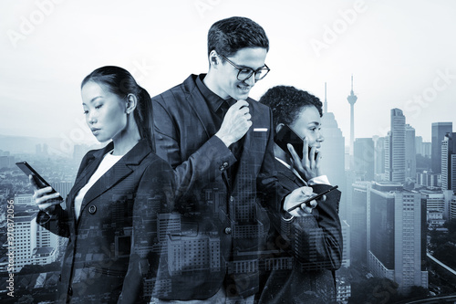 Photography Group of successful smiling businesspeople in suits using smart phone and thinking how to tackle the problem, new career opportunities, MBA