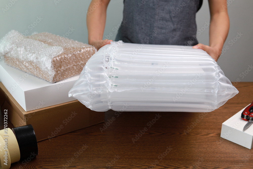 Packing products for delivery, shipping service. Translucent air packaging, protection of goods, bubble wrap packaging.