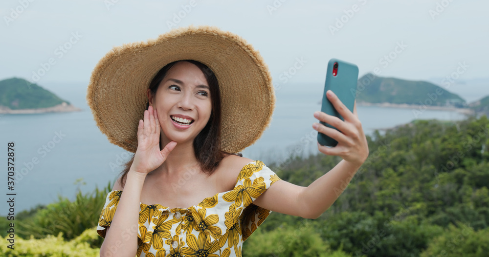 Fototapeta premium Travel woman take selfie on cellphone at countryside