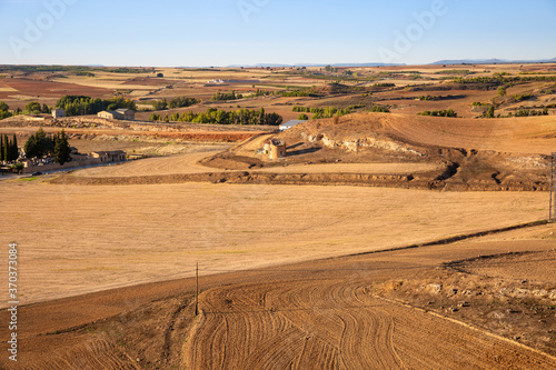 summer landscape with agricultural plowed fields next to San Esteban de Gormaz, province of Soria, Castile and Leon, Spain photo