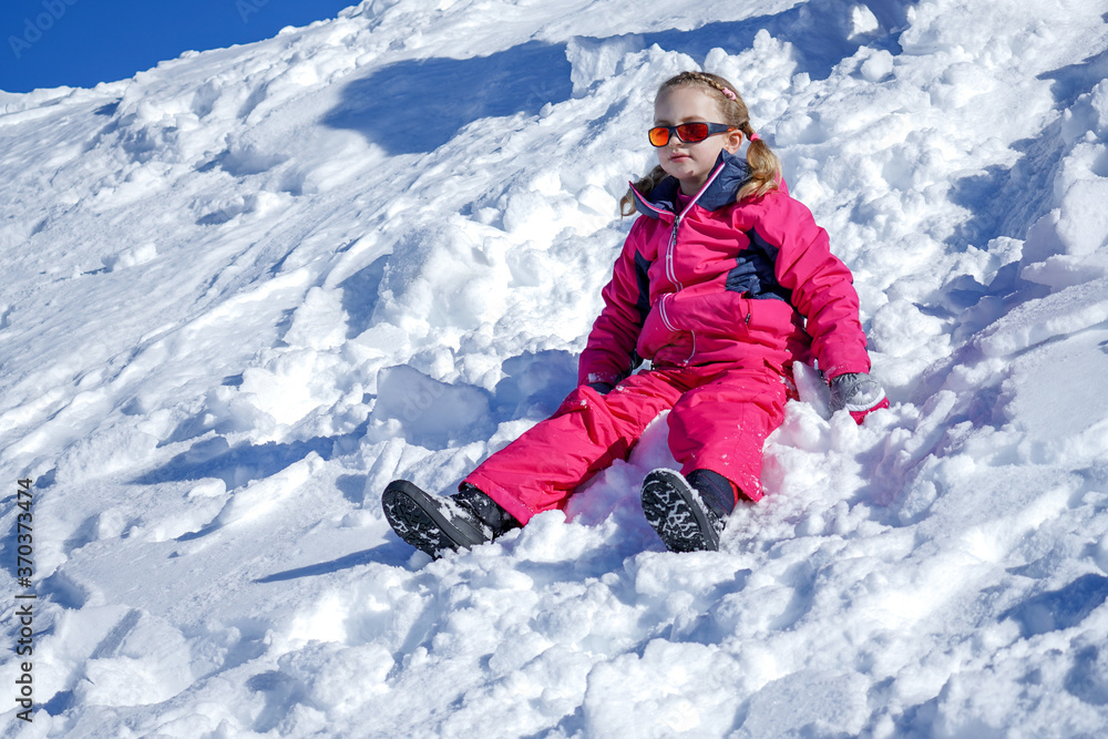 Young Girl Sitting On The Snow Mountain