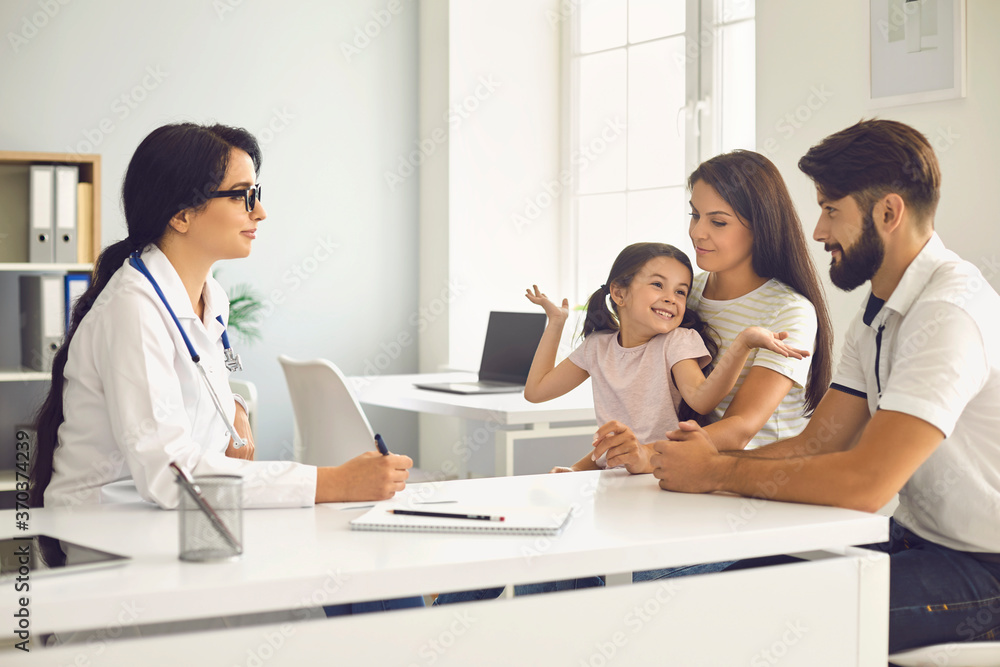Happy family at a medical consultation with a doctor in a clinic. Happy family at a medical consultation with a doctor in a clinic.