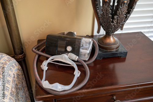 CPAP machine sitting on night stand.