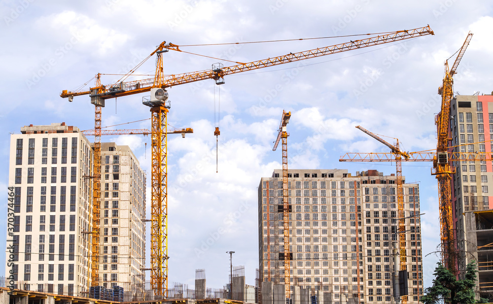Construction site with skyscrapers and tower cranes. Construction of residential areas. Construction site with skyscrapers and tower cranes. Construction of residential areas.