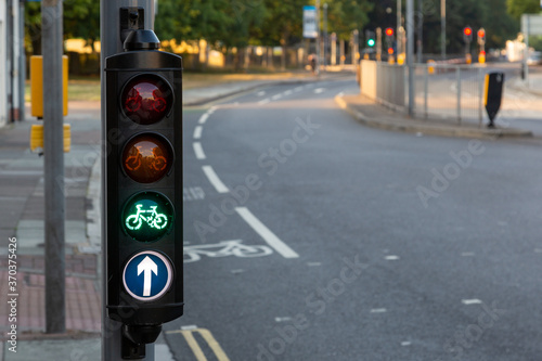 A set of cycle lane traffic lights at a junction of a cycle land showing green