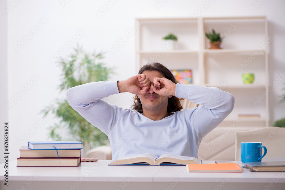 Young male student preparing for exams at home Young male student preparing for exams at home