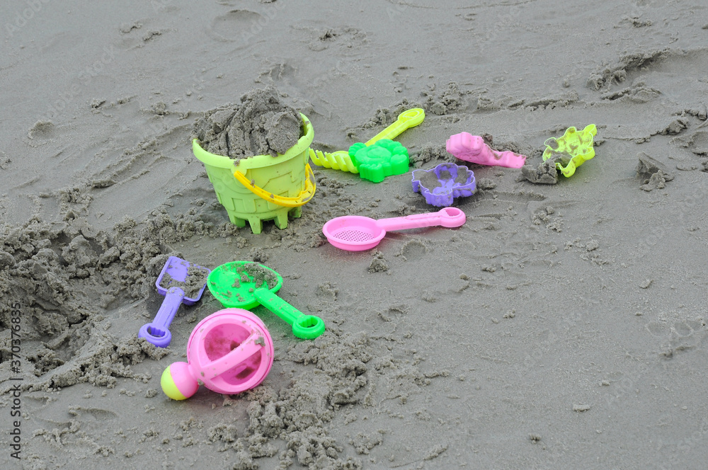 Some beach toys are made of plastic scattered randomly on the beach sand. Abandoned by children.
Some beach toys are made of plastic scattered randomly on the beach sand. Abandoned by children.