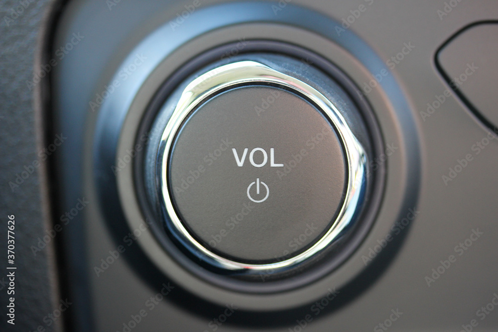 Close up of a volume knob and power button