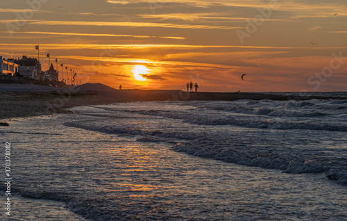 Langrune Sur Mer, France - 08 03 2020: Panoramic view of the sea from the beach at sunset photo