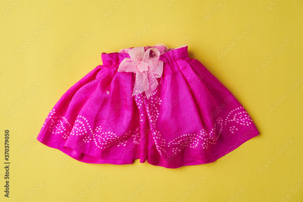 Baby clothes on a yellow background. Newborn baby clothing Baby clothes on a yellow background. Newborn baby clothing