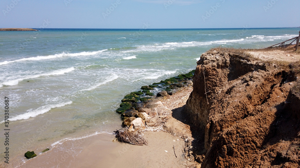 Rocks in the sea in the beach in the Torre Guaceto state nature reserve, Brindisi, Puglia, Italy Rocks in the sea in the beach in the Torre Guaceto state nature reserve, Brindisi, Puglia, Italy