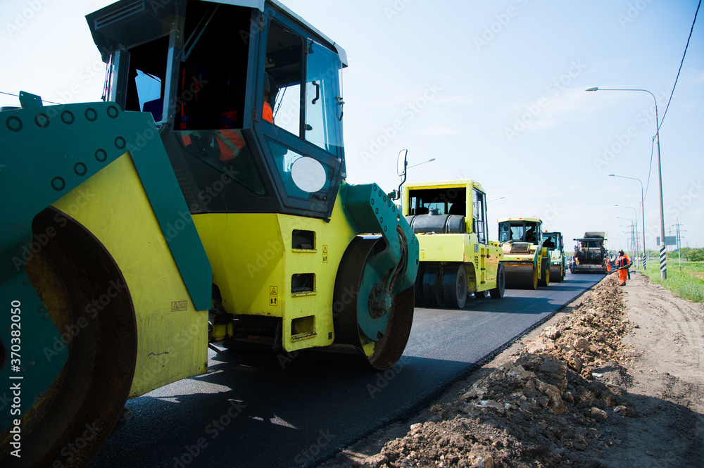 Fototapeta premium Repair of the old and construction of a new asphalt road