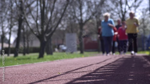 Wallpaper Mural Old people are running towards the camera. In total they are in defocus, when they are closer the foot is in focus. Torontodigital.ca