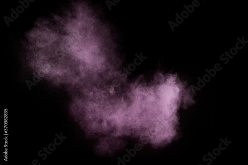 Purple powder explosion on black background. Colored powder cloud. Colorful dust explode. Paint Holi..