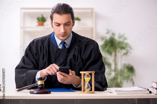 Young male judge in time management concept