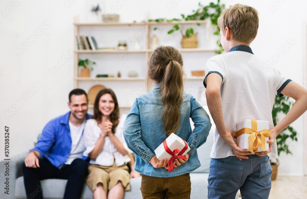 Obraz premium Children Giving Gifts To Their Happy Parents At Home