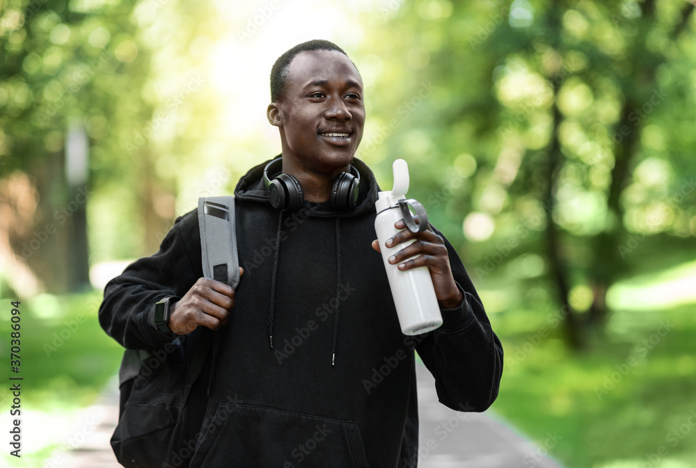 Balck guy in sport clothes holding bottle with water Balck guy in sport clothes holding bottle with water