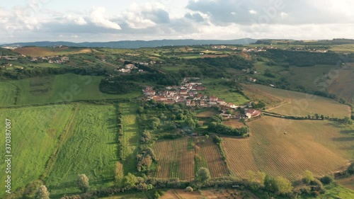 Aerial shot orbiting over Small picturesque village on Portuguese countryside environment photo